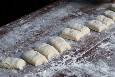 Roll of cut Dough preparation for make deep-fried dough or chinese dough in morning market of Thailandの写真素材