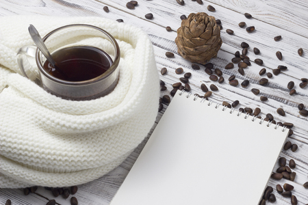Tea, scarf, pine nuts, notebook, wooden backgroundの写真素材