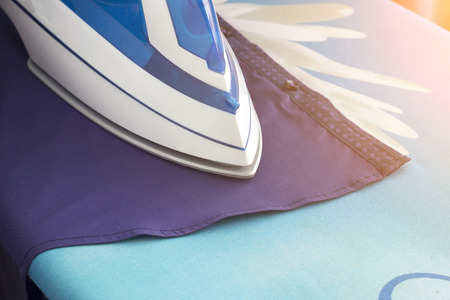 Iron, shirt, ironing board, close-upの写真素材