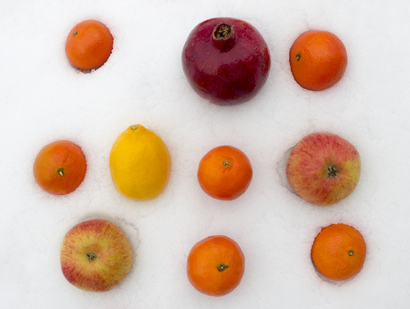 fruits on the snow, Tangerine, lemon, Apple, pomegranateの写真素材