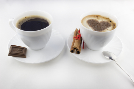 Two cups of coffee on a white background, cinnamon, chocolateの写真素材