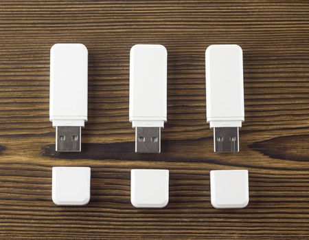 White flash drive on a wooden backgroundの写真素材