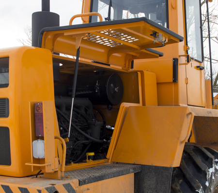 Broken tractor loader, engine compartment