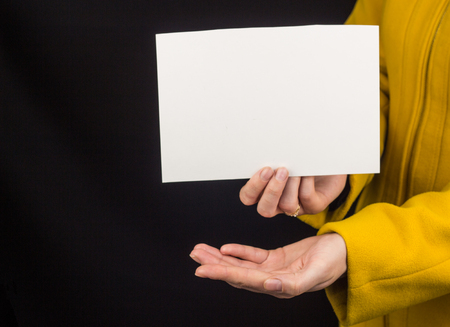 girl with outstretched palm and clean sheet for inscriptionの写真素材