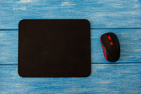 computer mouse pad and mouse on a blue wooden backgroundの写真素材