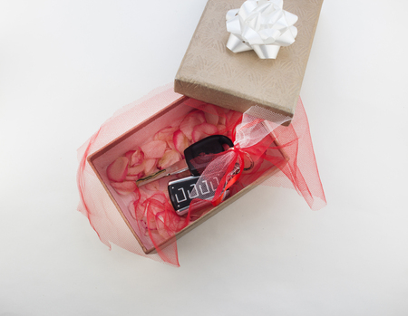Car keys in gift box, white background, close-upの写真素材