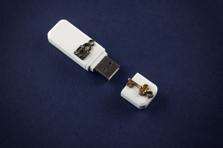 White flash drive with lock and key on a blue background, USBの写真素材