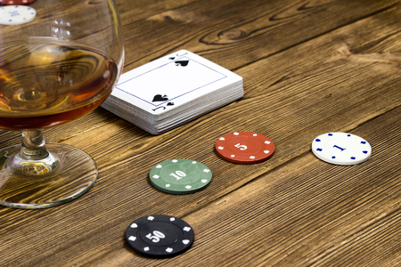 Poker chips card alcohol, wooden background, glass stackの写真素材