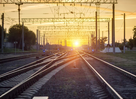 Branching of railways against the background of a bright sunset, transitの写真素材