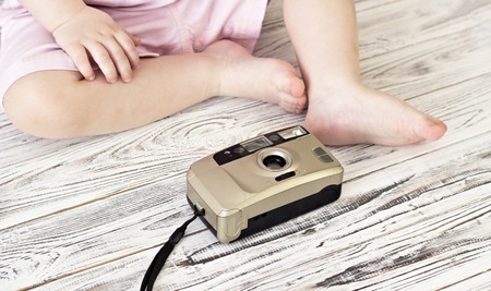 Little girl playing with camera, close-up, babyの写真素材