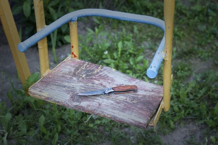 Folding knife lies on the child's swing, killing, kidnappingの写真素材