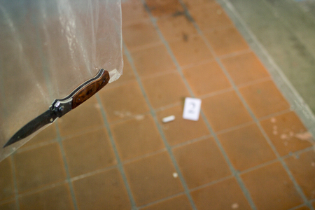 Stubby stub and folding knife in the forensic package, investigation, murder in the entrance, bag and markerの写真素材