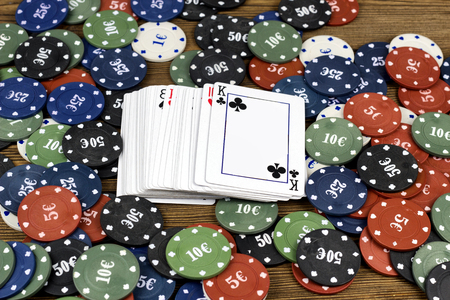 Cards and chips on a wooden background, Card deck and stackの写真素材
