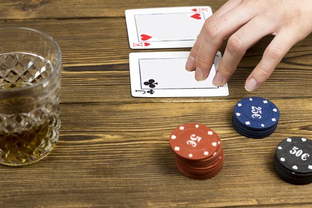 Poker chips card alcohol hand, wooden background, gambling and luckの写真素材