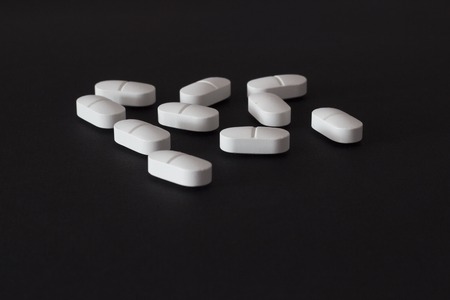 several pills on a black background, antibioticの写真素材