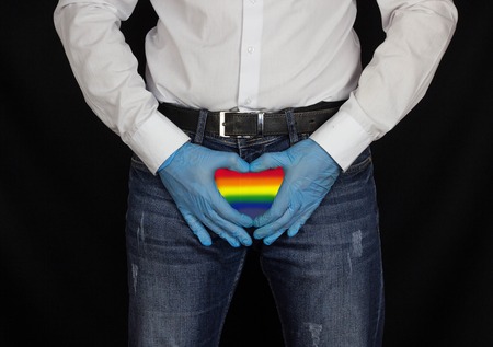 lgbt rights concept, A man in gloves shows a heart near the groin drawn as a flag of LGBTの写真素材