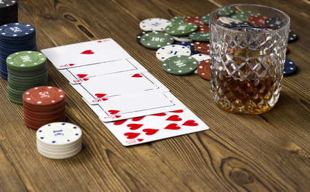 Poker chips card alcohol, wooden background, glassの写真素材