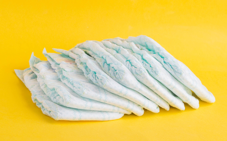Baby diapers on a yellow background, diaperの写真素材