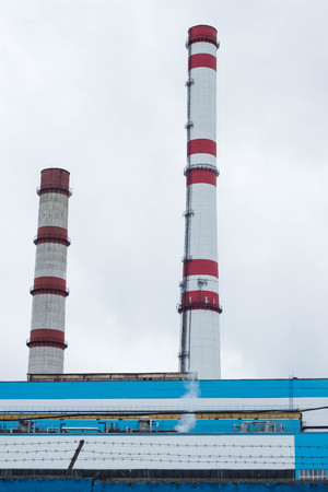 Two factory pipes against the sky, plant, pipeの写真素材