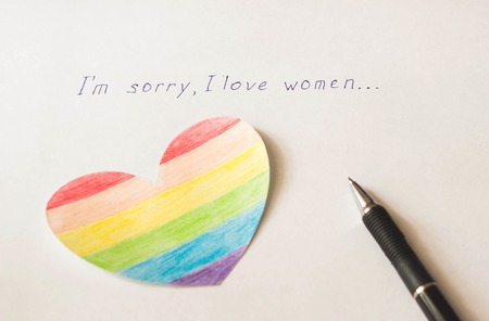 Inscription on white background I'm sorry I love women, heart in the form of a flag LGBT and a pen, lesbian and bisexualの写真素材