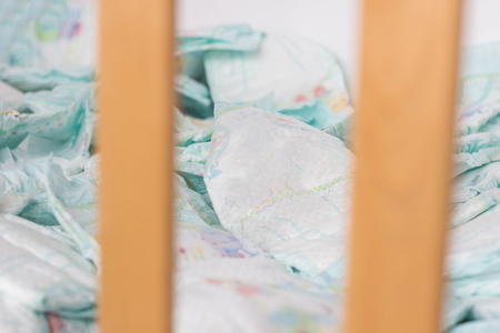 Baby diapers lie in a baby crib, close-upの写真素材