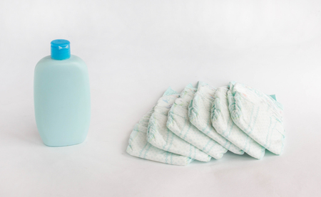 Baby diapers on a white background and baby shampoo, diaperの写真素材