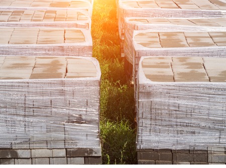 pallets with a paving slab made of mortar, brick, stone