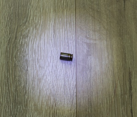 cartridge case a gun on the gray floor, close-up, dangerの写真素材