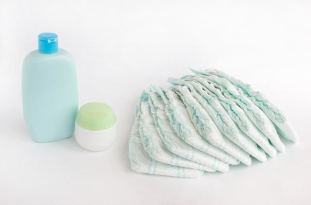 Baby diapers on a white background and baby shampoo, diaperの写真素材