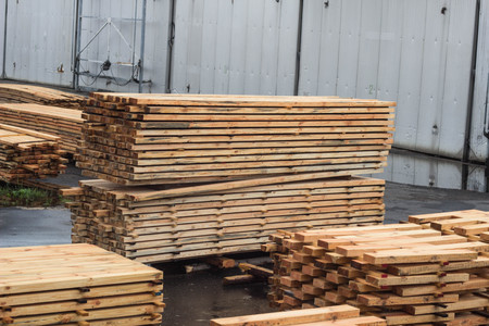 Carefully stacked stacks of wood boards at a woodworking plant, planking and exportの写真素材