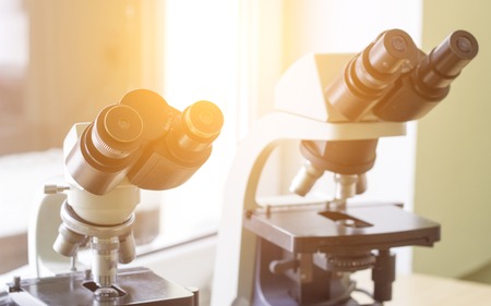 Two microscopes stand in the laboratory, close-up, sunlight, biotechnologyの写真素材