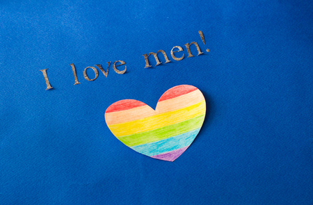 Heart in the form of a LGBT flag on a blue background and the inscription I love men, the concept of lgbt, lhomosexuality and heartの写真素材