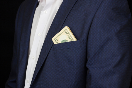 A man in a suit with a pocket is seen money dollars, ten dollars, studioの写真素材