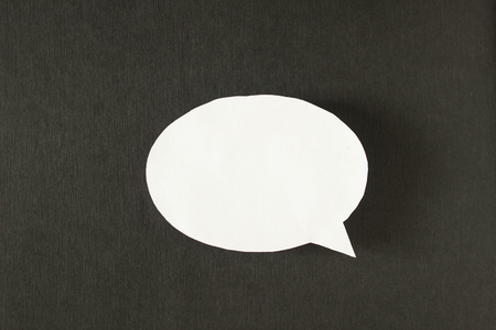 White bubble message from a paper on a black background, social networkの写真素材