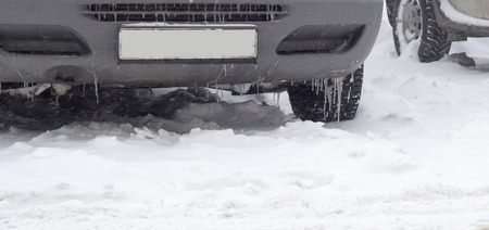 Icicles hang on the bumper of the car, winterの写真素材