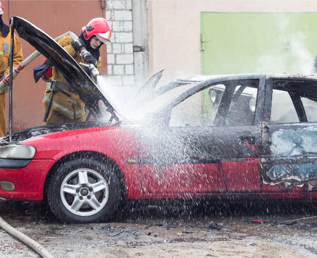 BOBRUISK, BELARUS - JULY 25, 2018: Two firemen extinguish a burning car, fire, automobileのeditorial素材