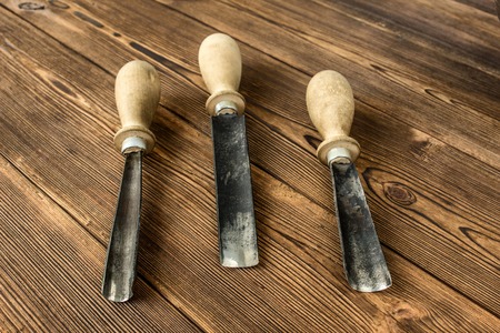 Cutters for wood carving, on a wooden background, close-up, cutterの写真素材
