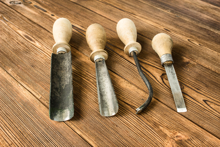 Cutters for wood carving, on a wooden background, close-up, cutterの写真素材