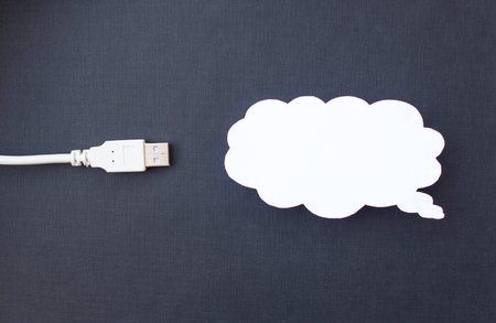 Cloud for data storage cut from paper on a black background and cable usb, close-up, cloudの写真素材