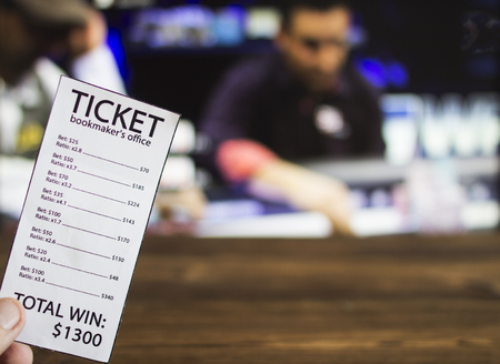 Bookmaker ticket on the background of the TV, which shows a game of cards, poker, sports betting, card, Bookmaker ticketの写真素材