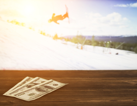 Money dollars on the background of a TV on which show sports freestyle, sports betting, freestyle, dollarsの写真素材