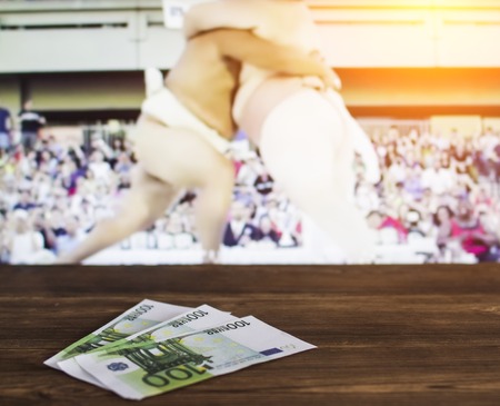 Euro money on TV background on which show sumo sport, sports betting, sumo, euroの写真素材