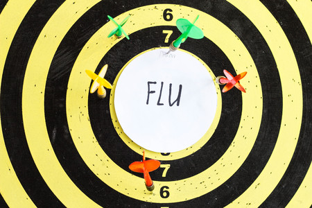 Target with darts in the center of which the inscription flu, close-upの写真素材