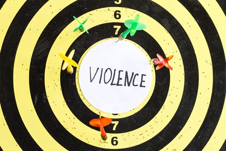Target with darts in the center of which the inscription violence, close-upの写真素材