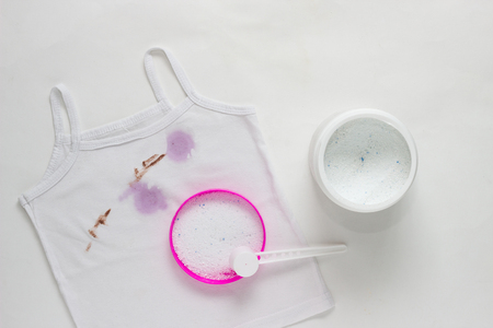Children's white T-shirt with dirty spots, stain remover, clothes and spots, powderingの写真素材
