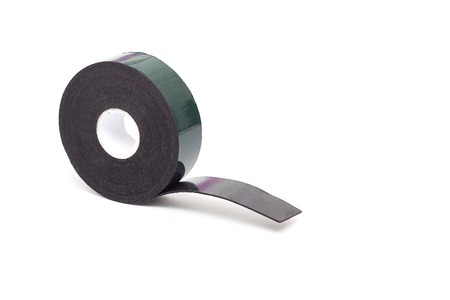 Reel of double-sided tape on a white background, isolate, green double-sided tape, close-up, scotch tapeの写真素材