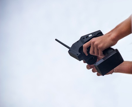 A man holds a radio-controlled remote in the hands of the car, competitions in radio-controlled models, toys, remote control, copy-spaceの写真素材
