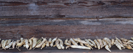 Pods of dried beans on a wooden background, a place for the inscription, kidney beanの写真素材