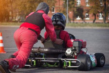 Karting competition, the participant pushes the young man in karting for karting, race, close-up, motorsportの写真素材
