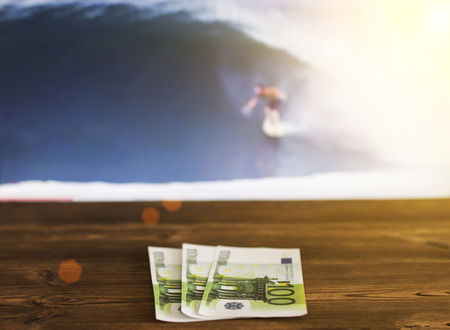 Euro money against the background of the TV, which shows surfing, sports betting, surfriding, euroの写真素材
